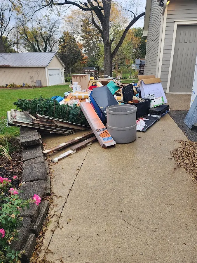Dumpster being loaded with debris for 12 Yard Dumpster Rental in Bacliff